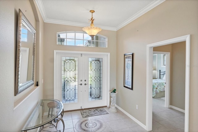 tiled foyer featuring french doors, ornamental molding, and baseboards