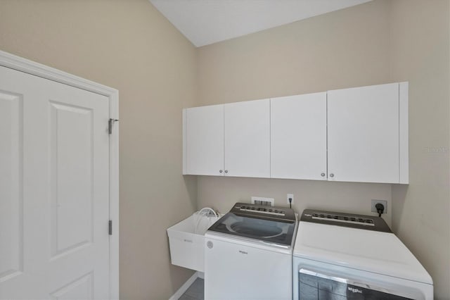 laundry room with independent washer and dryer, a sink, cabinet space, and baseboards