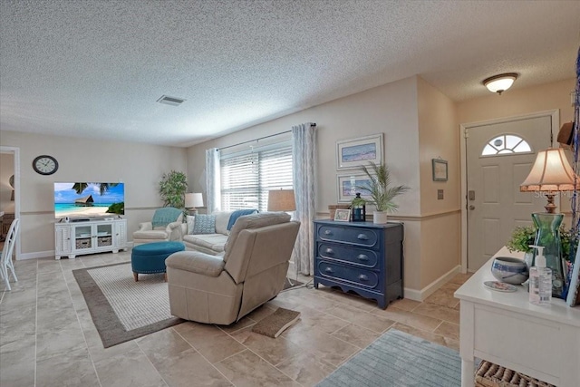 living room with visible vents and a textured ceiling