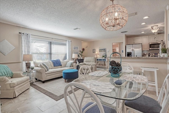 dining room featuring visible vents, a notable chandelier, a textured ceiling, recessed lighting, and light tile patterned floors