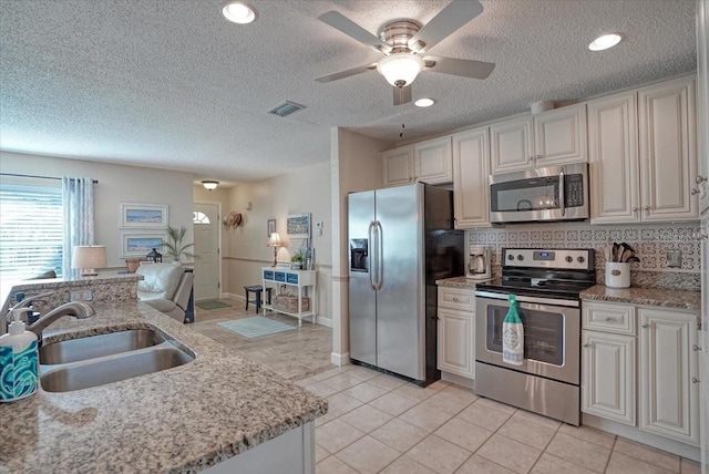 kitchen with light tile patterned floors, visible vents, appliances with stainless steel finishes, and a sink