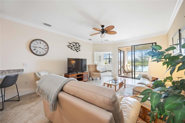 living room with a ceiling fan, baseboards, visible vents, and crown molding