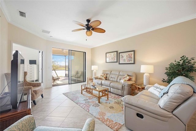 living area featuring light tile patterned floors, ceiling fan, visible vents, and crown molding