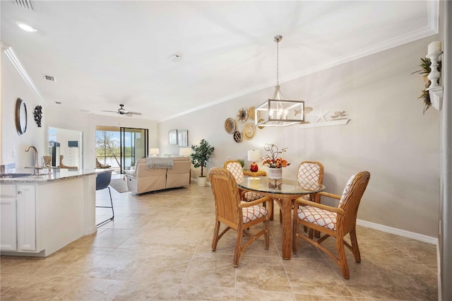 dining space featuring visible vents, crown molding, baseboards, and ceiling fan with notable chandelier