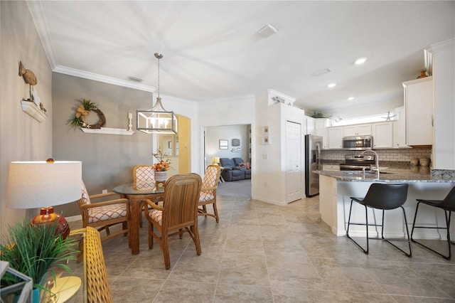 dining space featuring baseboards, visible vents, crown molding, a chandelier, and recessed lighting