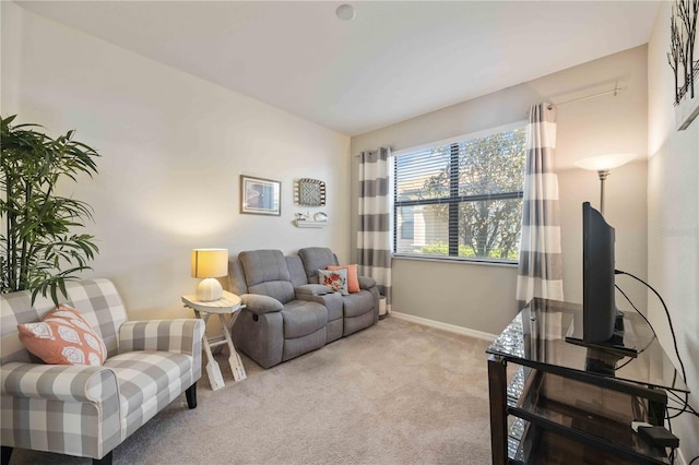 living room with baseboards and light colored carpet