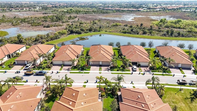 drone / aerial view with a water view and a residential view