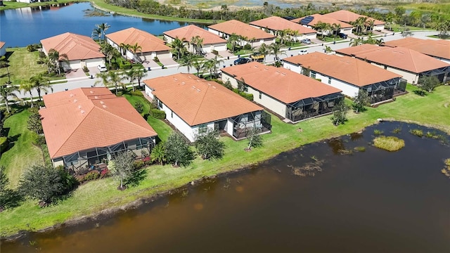 drone / aerial view with a water view and a residential view