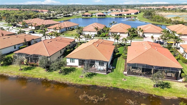 birds eye view of property with a water view and a residential view