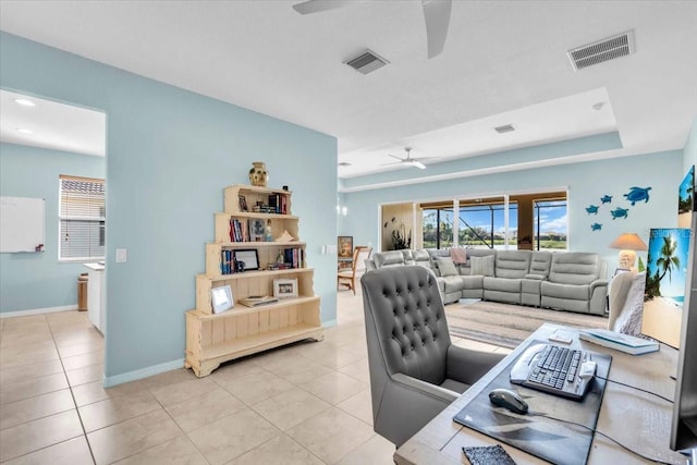 living room featuring light tile patterned floors, visible vents, baseboards, and a ceiling fan