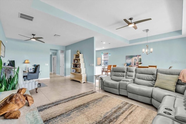 living room featuring light tile patterned floors, visible vents, and ceiling fan with notable chandelier