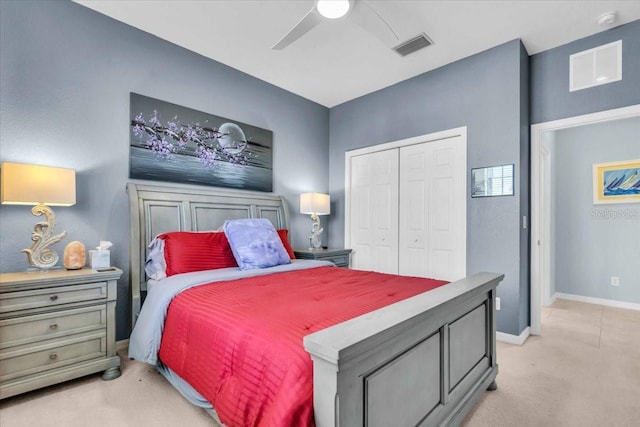 bedroom with a ceiling fan, visible vents, baseboards, a closet, and light colored carpet