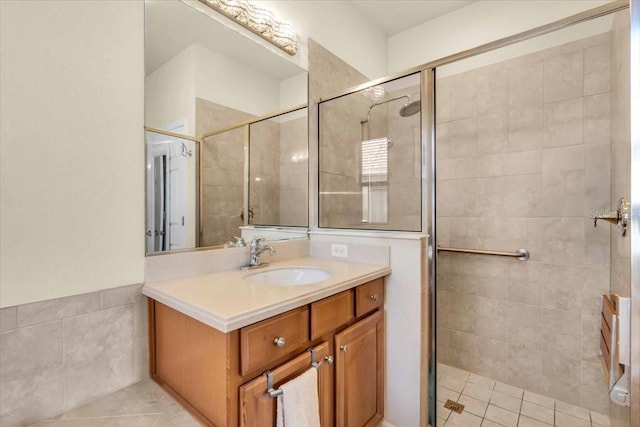 bathroom featuring tile patterned floors, a stall shower, and vanity