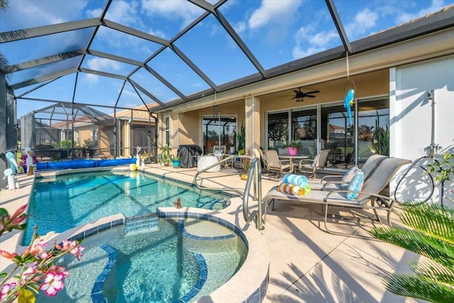 view of pool featuring a lanai, a patio, ceiling fan, and a pool with connected hot tub