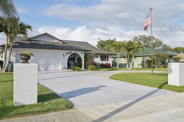 single story home with a garage, driveway, a front lawn, and a shingled roof