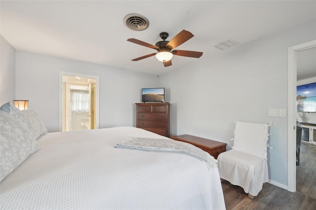 bedroom featuring a ceiling fan, baseboards, visible vents, and wood finished floors