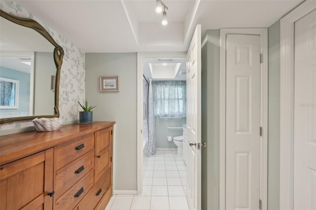 interior space featuring wallpapered walls, baseboards, and light tile patterned flooring