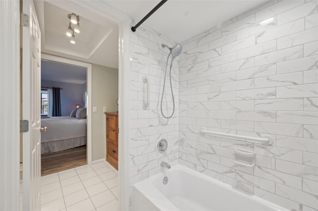 full bath featuring ensuite bathroom, baseboards, bathing tub / shower combination, and tile patterned floors