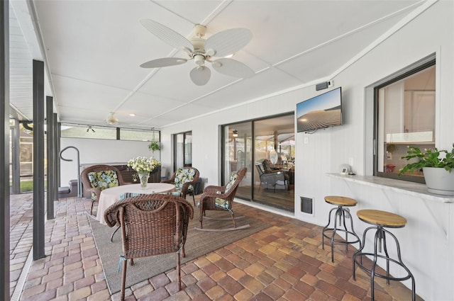 sunroom featuring visible vents and ceiling fan