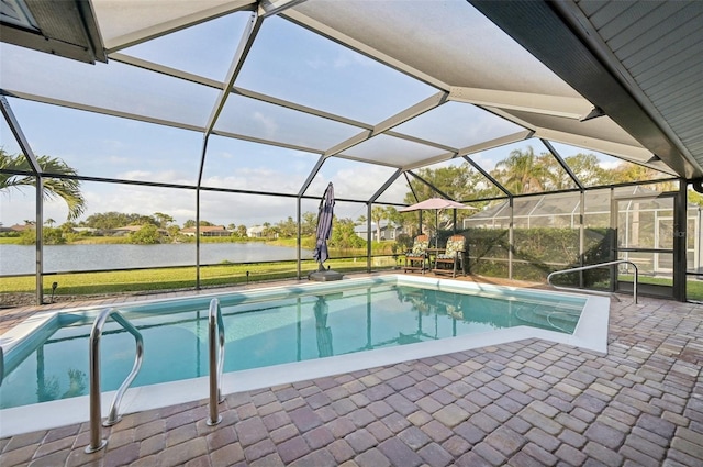 pool with glass enclosure, a water view, and a patio