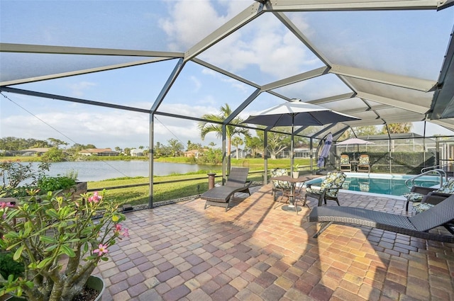 view of patio featuring a water view, a lanai, and an outdoor pool