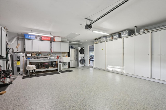 garage featuring a garage door opener, stacked washer / dryer, freestanding refrigerator, and electric water heater