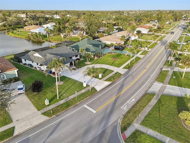 drone / aerial view featuring a water view and a residential view