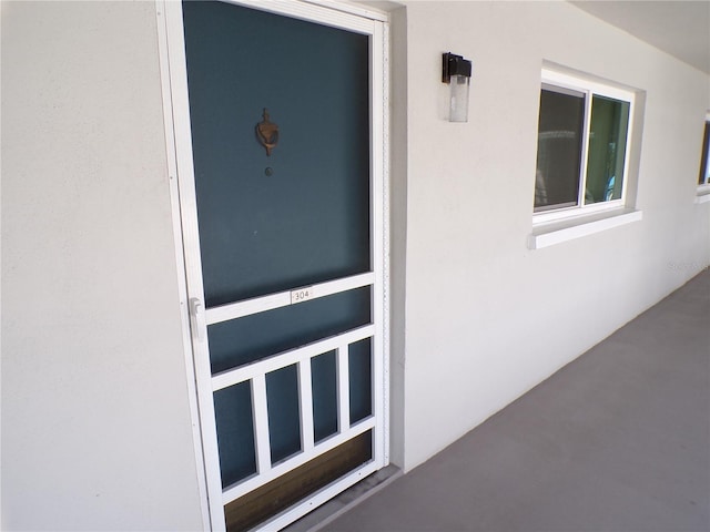 entrance to property featuring stucco siding