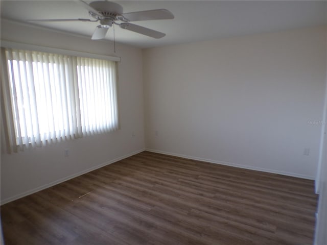 unfurnished room with a ceiling fan, baseboards, and wood finished floors