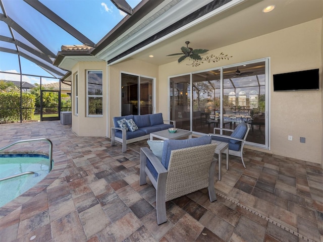 view of patio with an outdoor pool, glass enclosure, outdoor lounge area, and a ceiling fan