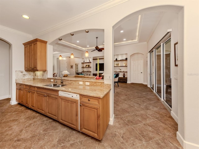 kitchen featuring arched walkways, ceiling fan, crown molding, a sink, and recessed lighting