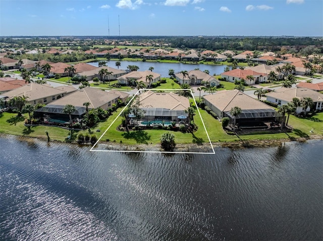 birds eye view of property with a water view and a residential view