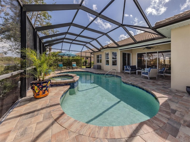 view of pool with a pool with connected hot tub, glass enclosure, a patio, and an outdoor hangout area