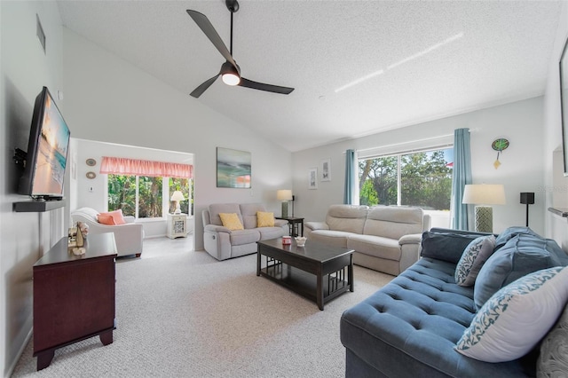 carpeted living area with high vaulted ceiling, visible vents, ceiling fan, and a textured ceiling