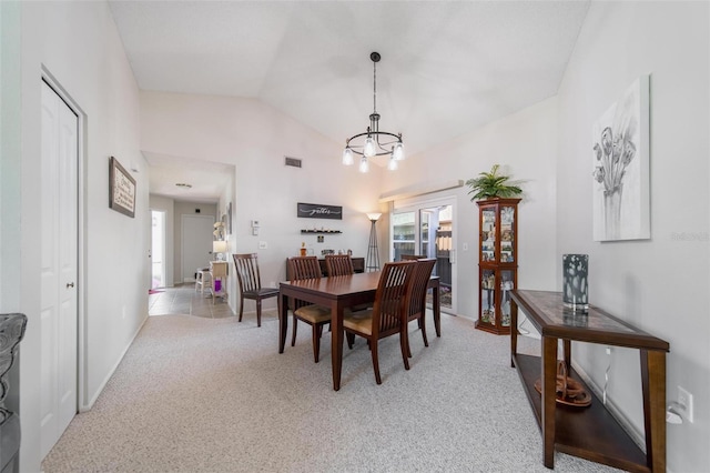 dining area with an inviting chandelier, visible vents, vaulted ceiling, and light colored carpet