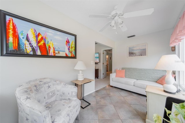 living area featuring ceiling fan, visible vents, and light tile patterned flooring