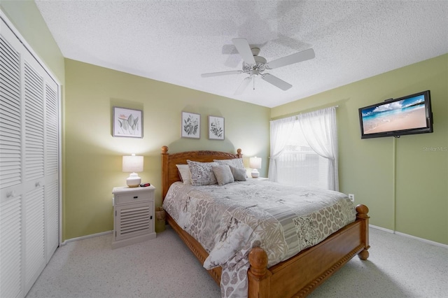 bedroom featuring a textured ceiling, a ceiling fan, baseboards, a closet, and carpet