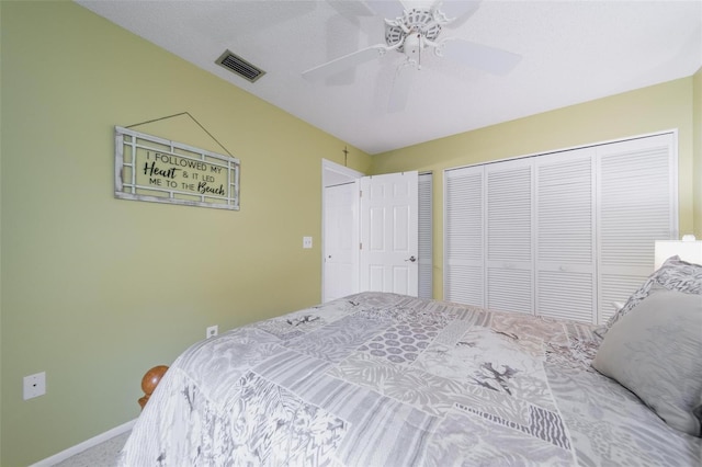 bedroom with ceiling fan, visible vents, baseboards, carpet, and two closets