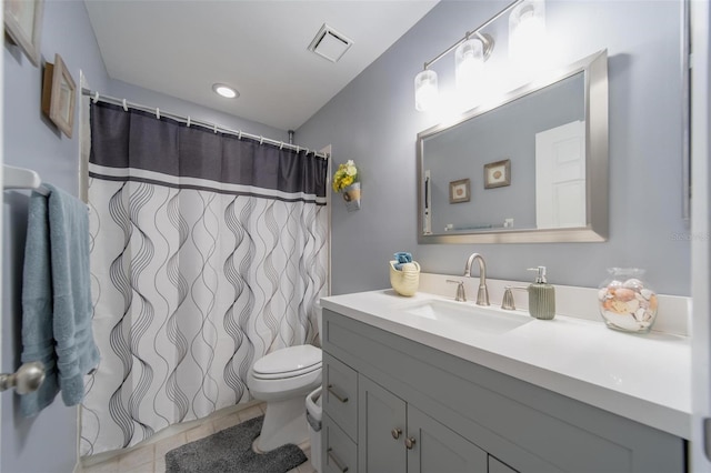 bathroom with visible vents, a shower with shower curtain, toilet, tile patterned floors, and vanity