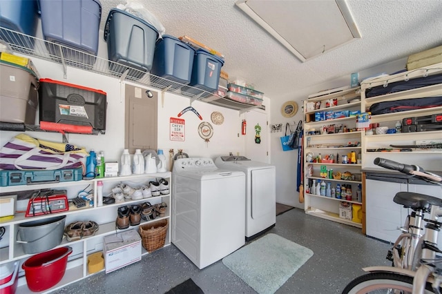 washroom featuring laundry area, washing machine and dryer, attic access, and a textured ceiling