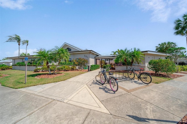 single story home featuring a front lawn