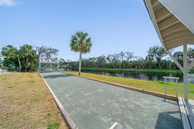 view of community featuring a water view and a lawn