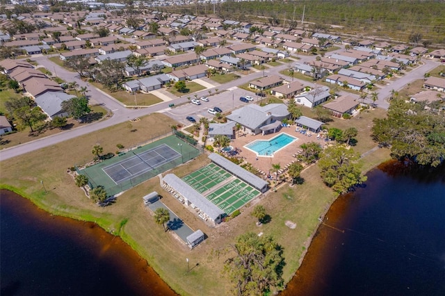 drone / aerial view featuring a residential view and a water view