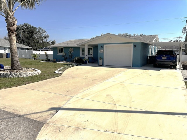 ranch-style house with driveway, a garage, fence, a front yard, and stucco siding