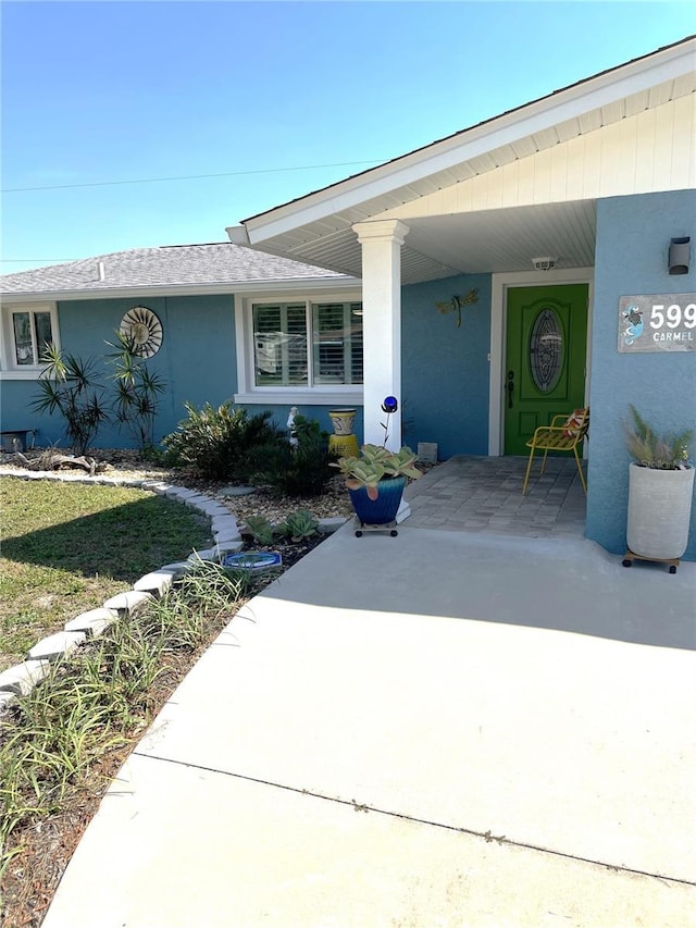 property entrance featuring stucco siding