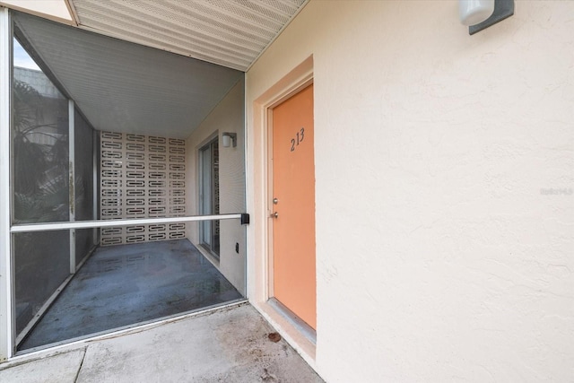 entrance to property with stucco siding