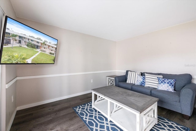 living area featuring baseboards and wood finished floors