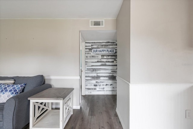 interior space with wainscoting, wood finished floors, and visible vents