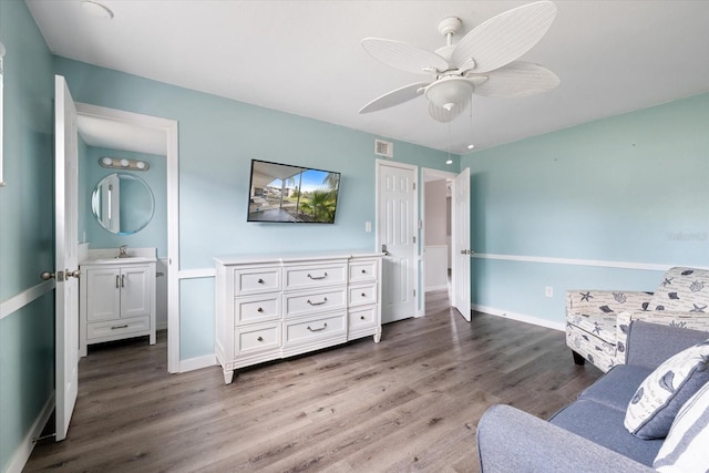 sitting room featuring baseboards, wood finished floors, visible vents, and a ceiling fan