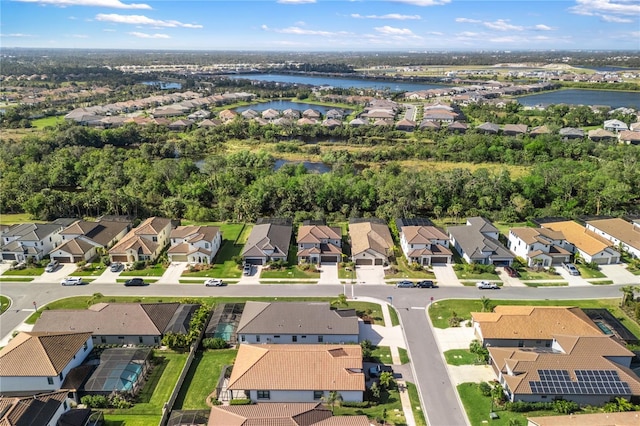 drone / aerial view featuring a residential view and a water view